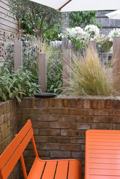 Orange furniture in the courtyard adds a pop of colour